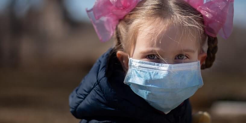 Un enfant portant un masque chirurgical